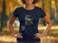 In a park with blurred autumn foliage, someone wears a stylish navy blue T-shirt by Garment Graphics, ideal for automotive enthusiasts.