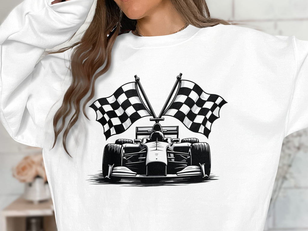 A person models a Garment Graphics sweatshirt featuring a striking black and white design of a formula race car with two crossed checkered flags. The unique racing car print adds flair, while the softly blurred background maintains focus on the standout design.