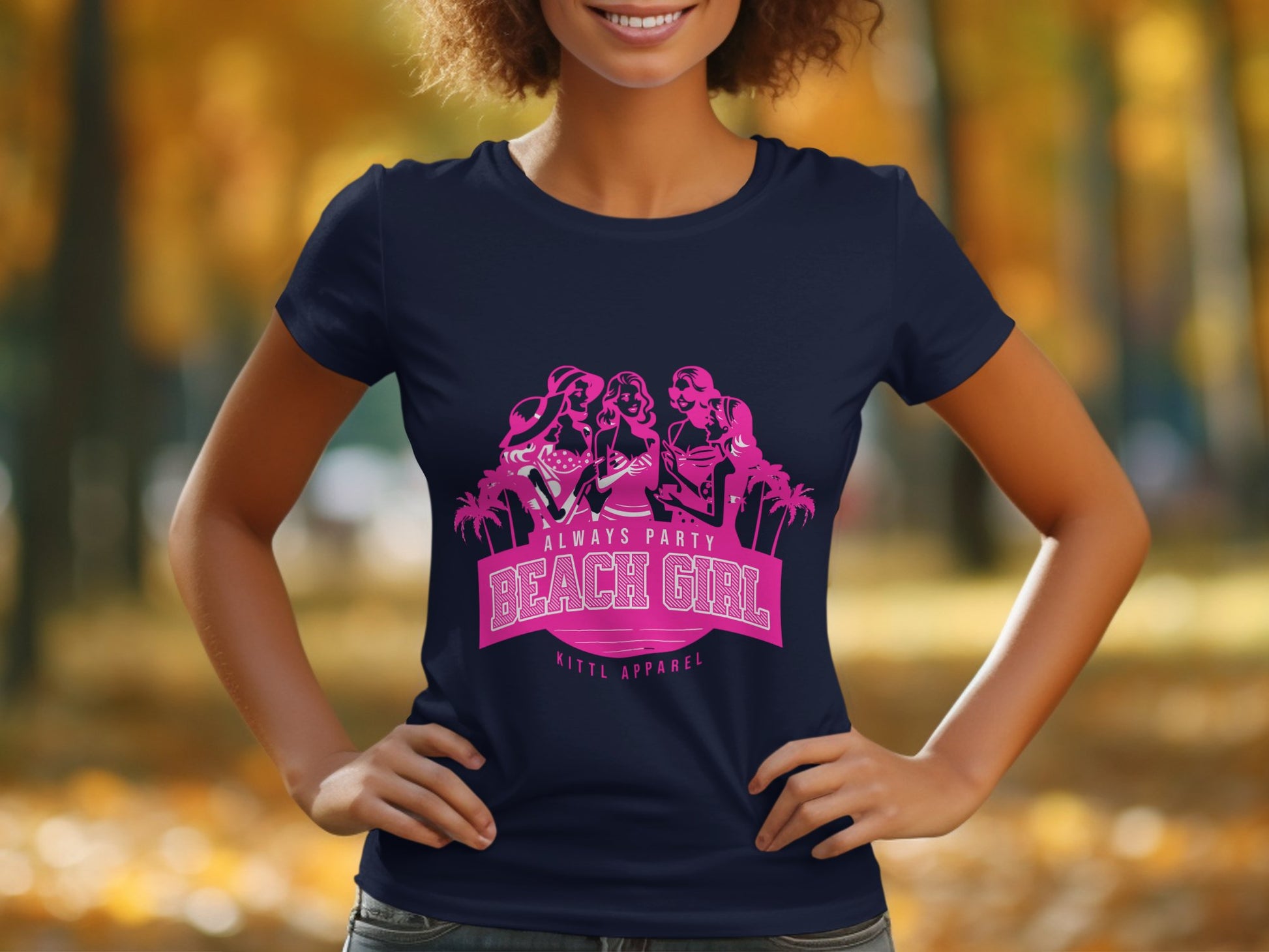 Wearing a Garment Graphics navy blue t-shirt featuring a pink graphic with three cartoon figures and palm trees from the Beach Girl T-Shirts collection, the person stands outdoors with blurred autumn trees. It reads, Always Party Beach Girl Kittl Apparel.