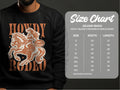 A person sports a Garment Graphics black graphic print sweatshirt featuring a cowboy on horseback with Howdy Rodeo and Not Beginners. To the right is a Gildan 18000 Heavy Blend Crewneck Sweatshirt size chart, showing unisex sizes from S to 5XL.