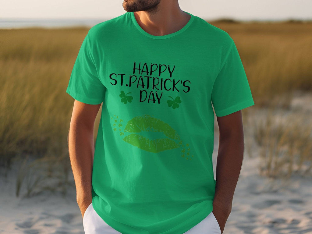 A person in a grassy area wears a Garment Graphics T-shirt featuring Happy St. Patricks Day with two shamrocks and vibrant green lips, capturing the festive spirit.