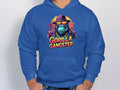 Sporting a blue hoodie from Garment Graphics, a man showcases striking gorilla artwork featuring a gorilla with a hat and sunglasses. The Gorilla Gangster text enhances its appeal, making it a standout in streetwear fashion.