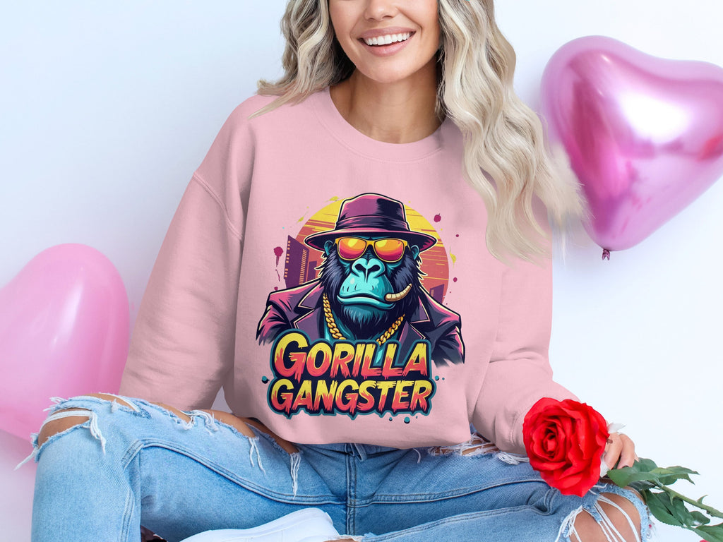 A woman with long, wavy hair exudes urban style in a pink Garment Graphics sweatshirt featuring a Gorilla Gangster image. She sits elegantly, holding a red rose, as two pink heart-shaped balloons float behind her.