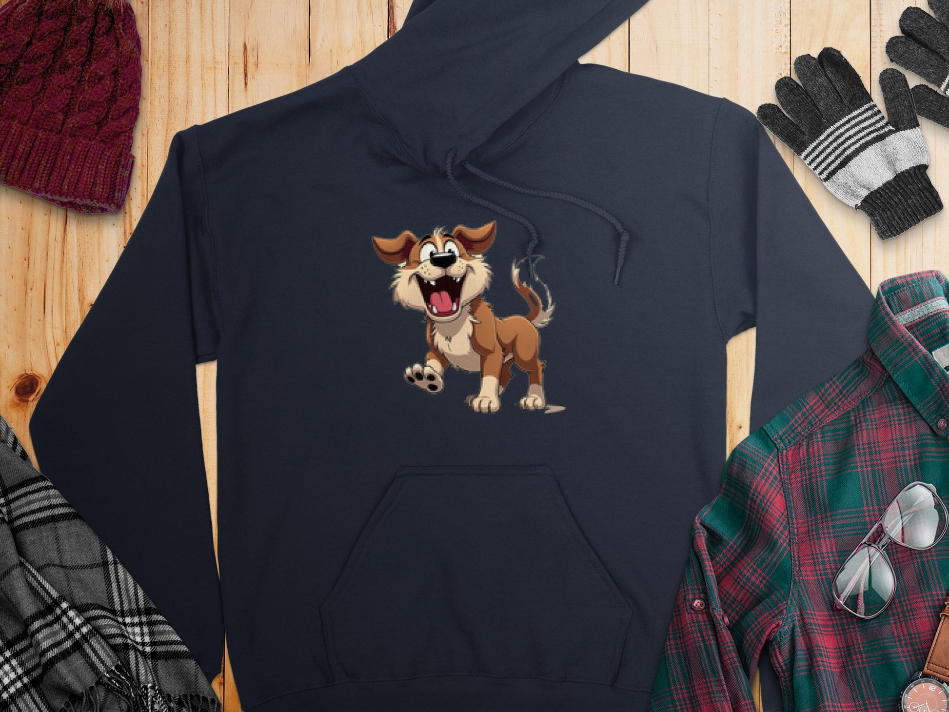 The Garment Graphics navy hoodie showcases a cheerful cartoon dog illustration. Its paired with a red knit hat, gray and black gloves, a plaid scarf, and a green and red plaid shirt, creating the perfect ensemble for dog lovers.