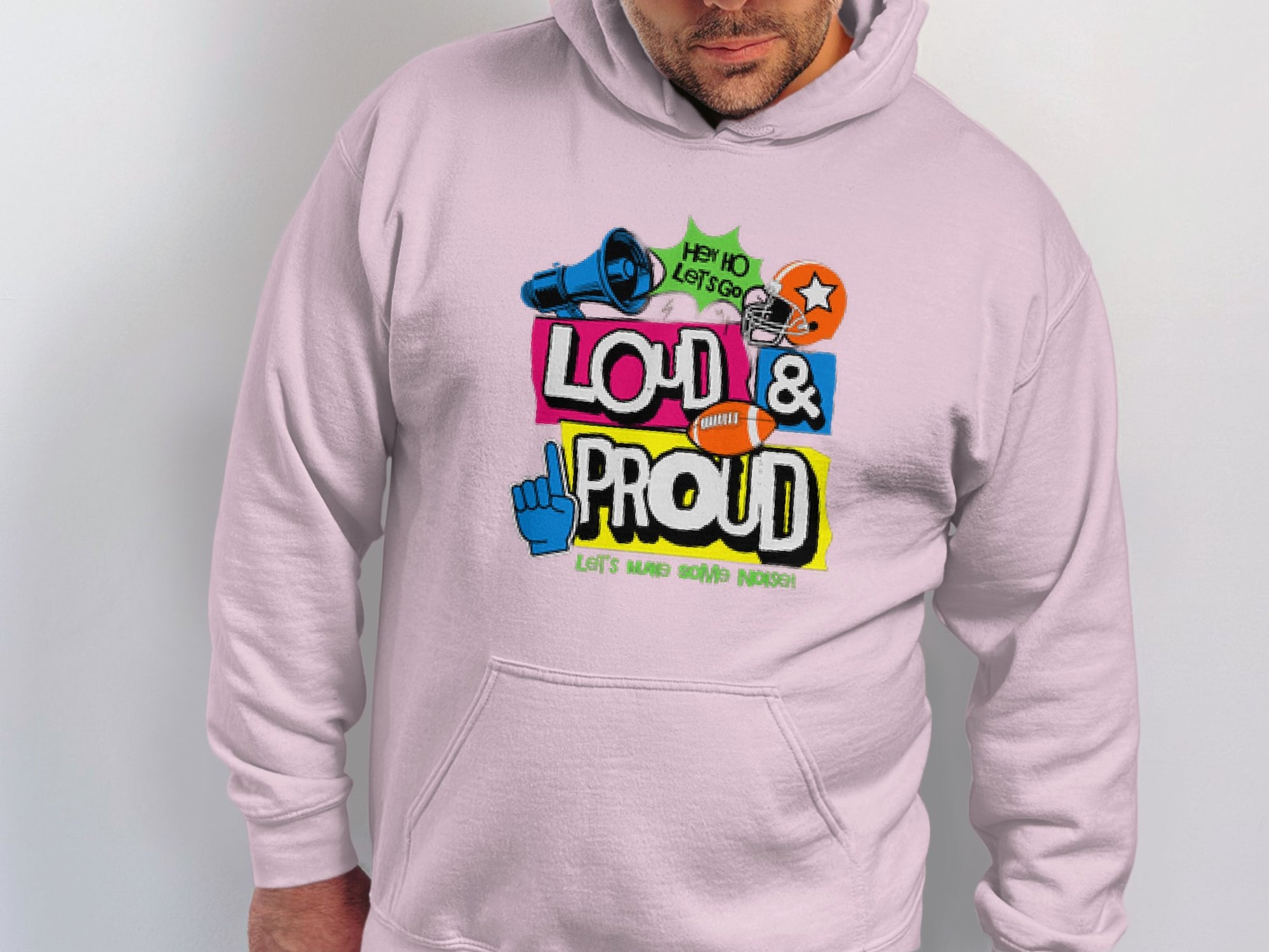 Wearing a Garment Graphics light-colored hoodie makes a bold statement with its vibrant design. Emblazoned with Loud & Proud, it showcases icons like a megaphone, star, hand, and the text Hey Ho Lets Go! Perfect for fans of Lets Make Some Noise Hoodies.