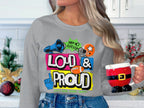 In a kitchen adorned with holiday decor, someone holds a Santa-themed mug, wearing a Garment Graphics gray Loud & Proud Sweatshirts top embellished with vibrant megaphone, football, and foam finger graphics—showcasing their distinct style.