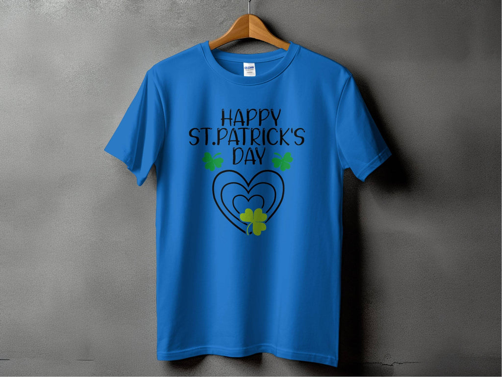 Garment Graphics graphic T-shirt exudes festive flair with Happy St. Patricks Day in bold black text, green shamrocks, and a heart design on a gray background. This blue tee is perfect for stylish celebrations, displayed on a wooden hanger.