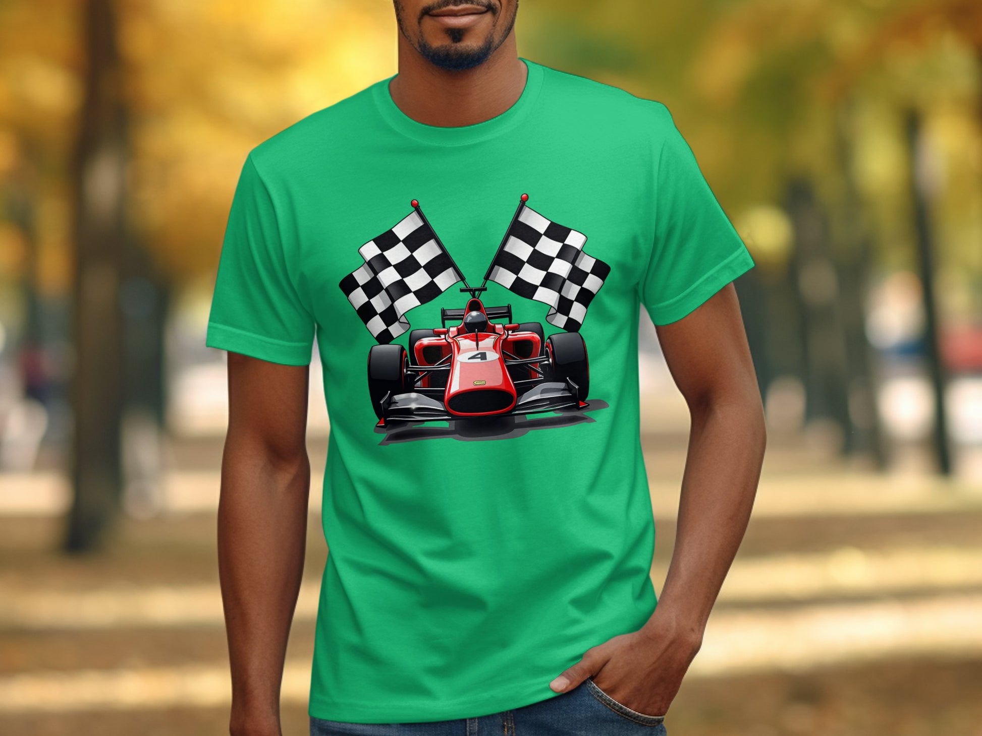 A person in a Garment Graphics green T-shirt with a vivid red racing car and two checkered flags graphic stands outside, surrounded by blurred trees and fallen leaves, capturing the excitement of motorsport.