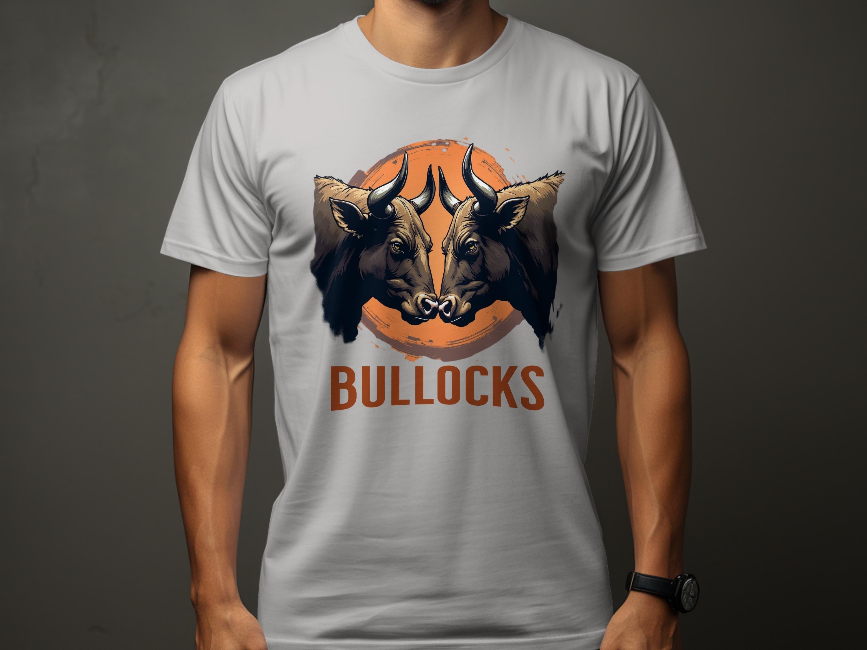 Wearing a Garment Graphics Classic Fit gray T-shirt, one can showcase a bold design with two bull heads against an orange circle and the word BULLOCKS below, making the Bullocks Pintable T-Shirts pop on its dark background.