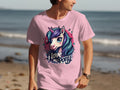 A unicorn enthusiast enjoys a beach walk in a pink Garment Graphics T-shirt featuring a colorful unicorn and the phrase I Love My Pony, with the ocean and sand creating a serene backdrop.