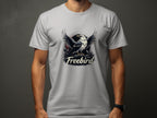 A person is wearing a bold Garment Graphics Freebird eagle T-Shirt, made of 100% cotton, featuring an eagle with spread wings and Freebird in bold. They pose against a plain, dark background.