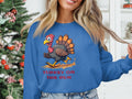 A person wears a Garment Graphics blue sweater with a funny cartoon turkey and Turkey on the Run print, set against a background of a decorated Christmas tree and white shelves, showcasing this sweatshirts charm and unisex sizing.