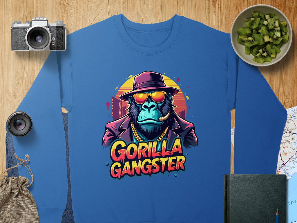 Garment Graphics presents an urban sweatshirt featuring a gorilla in a hat and sunglasses, smoking a cigar. Gorilla Gangster is printed among motifs like a camera, photo lens, cucumber bowl, map, and notebook—ideal for bold aesthetic enthusiasts.