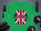 Garment Graphics offers a unisex green sweatshirt with a distressed Union Jack and DONT BLAME ME, I Didnt Vote For Him message. Displayed on gray, its surrounded by a smartphone, smartwatch, headphones, black shoes, and dumbbells.