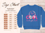 Garment Graphics offers a blue crewneck sweatshirt with a Just be Cool Rock and Roll design featuring pink headphones, perfect for music lovers. Available in sizes S to 5XL, this Gildan 18000 Heavy Blend is an ideal fashion statement piece, accented by a leaf pattern background.