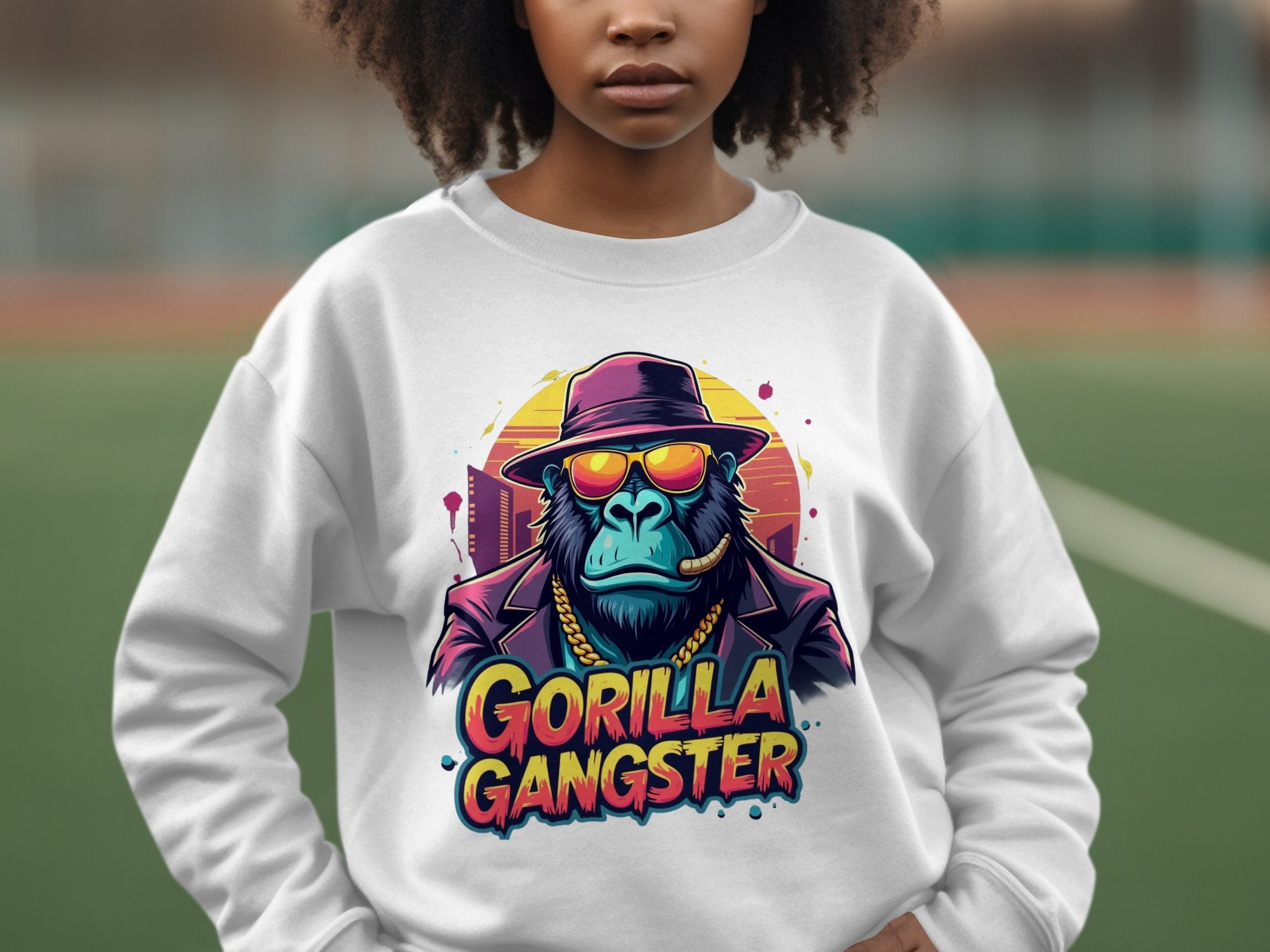 Wearing Garment Graphics urban sweatshirt, featuring a vibrant gorilla graphic dressed as a gangster with sunglasses, hat, coat, and gold chain. The cool design is topped off with the bold text Gorilla Gangster.
