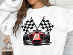 A motorsport enthusiast wears a vibrant Garment Graphics sweatshirt featuring a red racing car with the number four, surrounded by checkered flags, while keeping their face hidden.