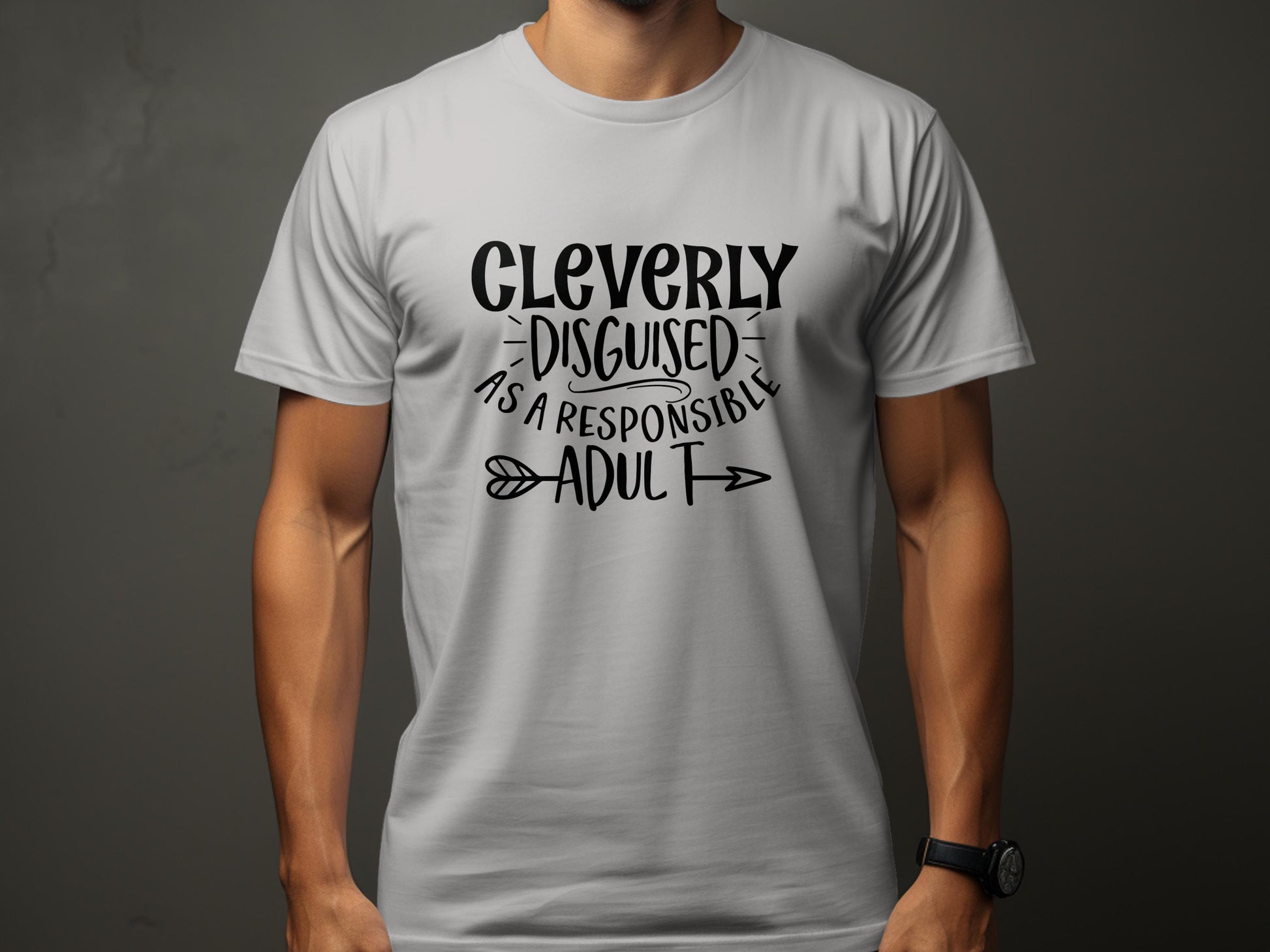 Dressed in a Garment Graphics classic fit light gray T-shirt featuring bold, black text saying Cleverly Disguised as a Responsible Adult, perfect for casual outings with its neutral backdrop enhancing the fun message.