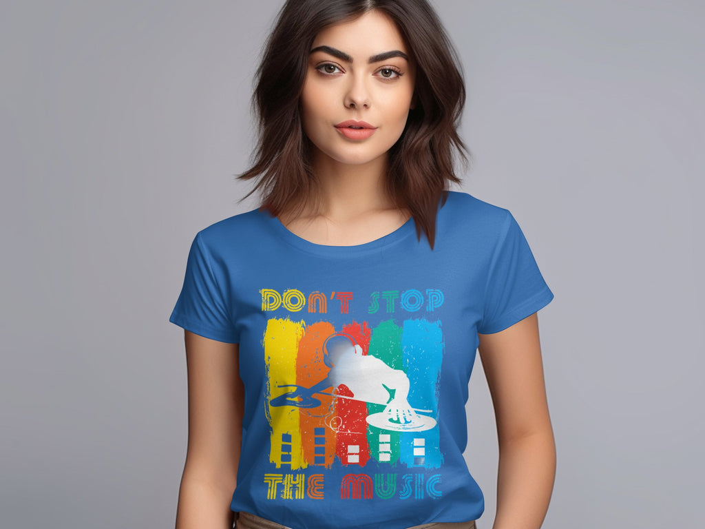 A person wearing a Garment Graphics blue DJ tee, showcasing a vibrant DJ silhouette and the text Dont Stop the Music, set against a light gray background. Its ideal for music enthusiasts.