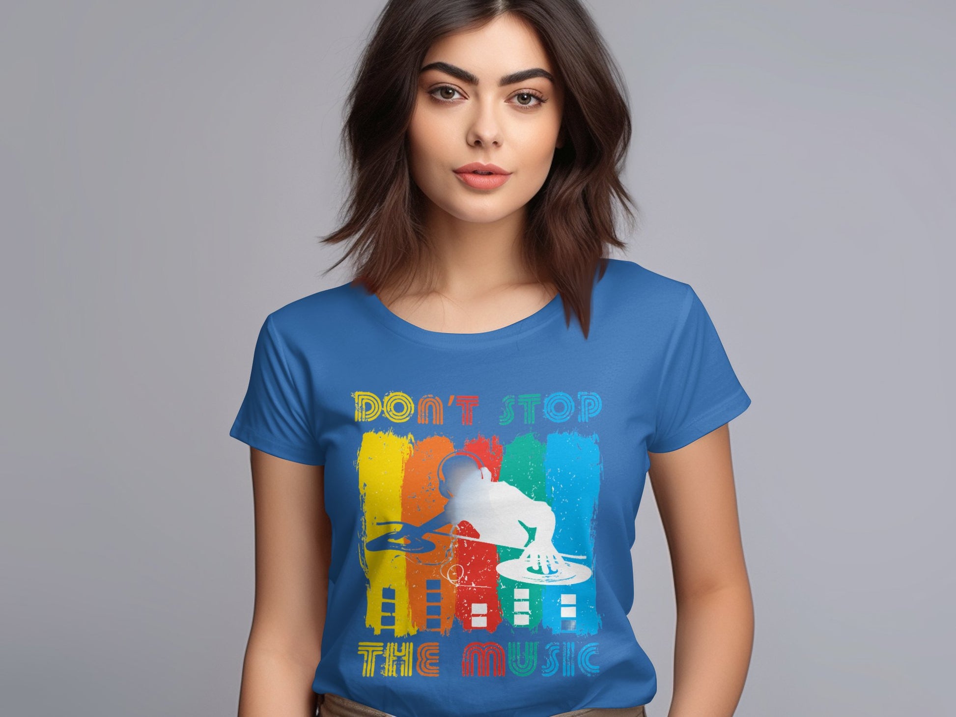 A person wearing a Garment Graphics blue DJ tee, showcasing a vibrant DJ silhouette and the text Dont Stop the Music, set against a light gray background. Its ideal for music enthusiasts.