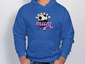 Wearing a cozy blue hoodie by Garment Graphics, a person stands against a plain background. The classic fit features Soccer Mum in bold and an illustration of a soccer ball with stars above it, offering warmth and comfort.