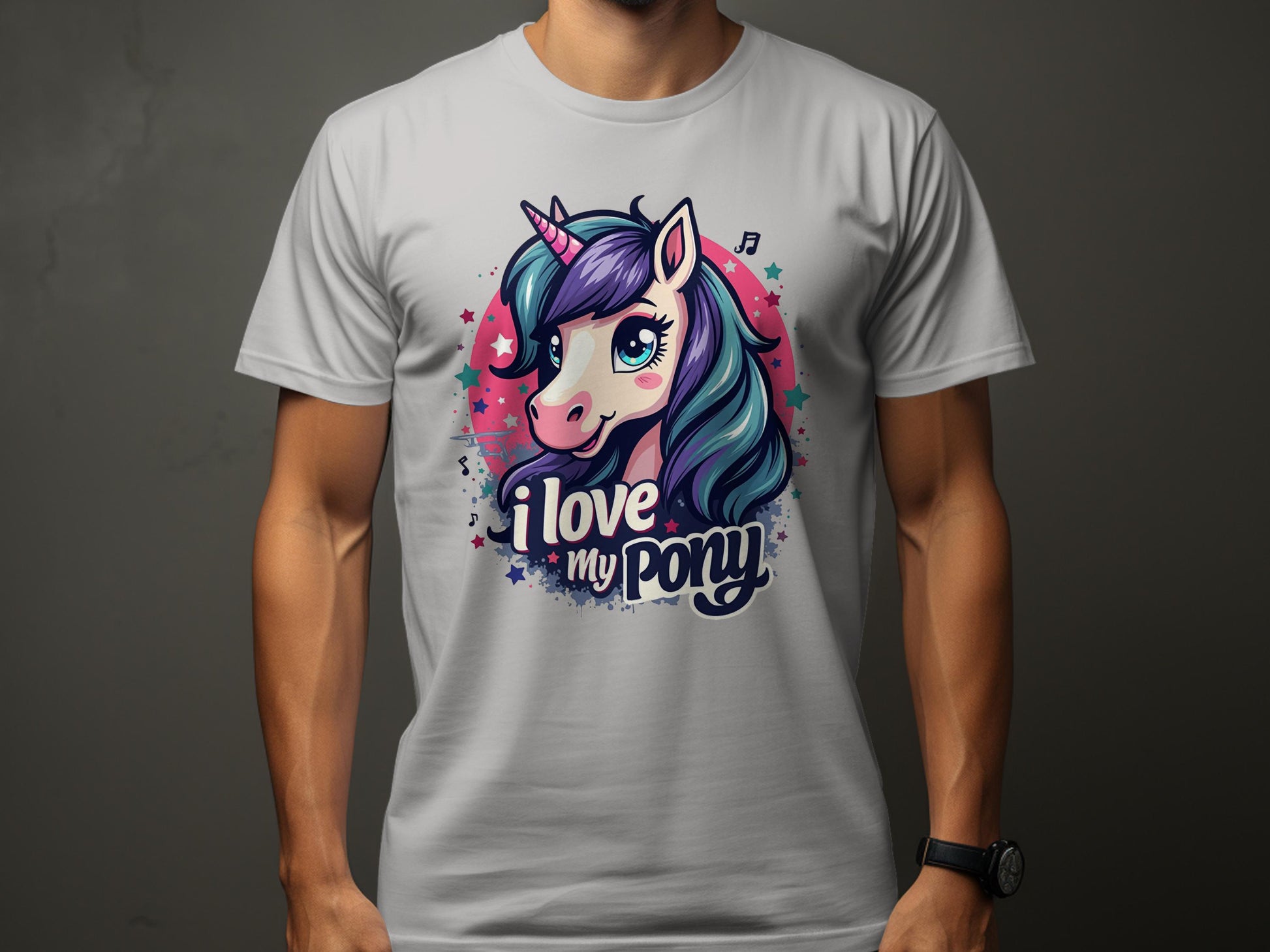 A unicorn enthusiast wears a colorful Garment Graphics T-shirt featuring a cartoon unicorn with a purple mane and blue eyes, surrounded by playful stars and music notes, and the text I love my pony.