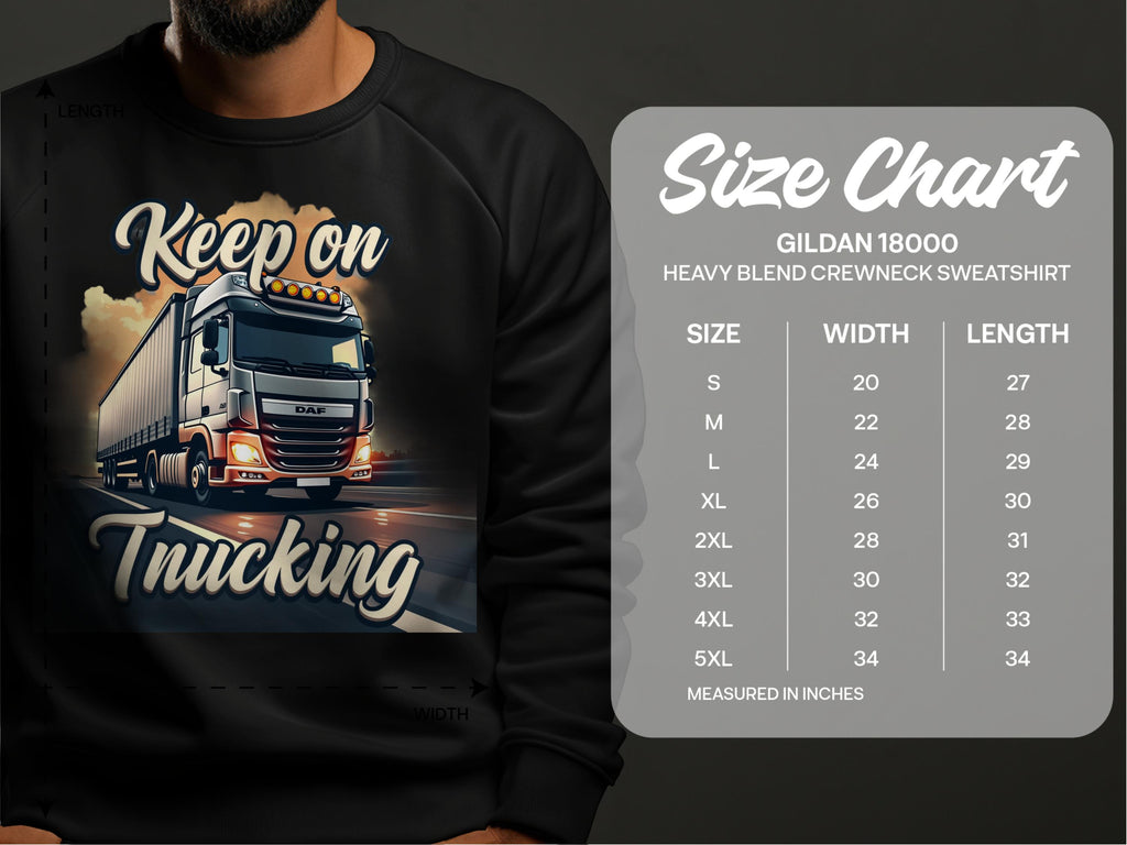 A man wears a Garment Graphics black sweatshirt featuring a truck illustration and Keep on Trucking. A Gildan 18000 size chart (S to 5XL) is beside him, ideal for those embracing the open road.