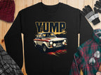 Garment Graphics black sweatshirt with a rally car graphic, racing stripes, and YUMP text. Displayed with a plaid shirt, scarf, gloves, beanie on a wooden background.