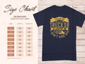 A navy blue Garment Graphics T-shirt features yellow text: If hes got golf clubs in his truck or a camper in his driveway, dont hire him. Ideal for golf and camping fans. A size chart for the Gildan 5000 heavy cotton T-shirt shows sizes S to 5XL with width and length in inches.
