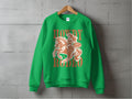 Experience unisex sizing and vibrant design with Garment Graphics green sweatshirt. Displayed on a wooden hanger against a concrete wall, it showcases a line drawing of a horse and rider with Howdy Rodeo and (Howdy, partner!) in a charming speech bubble.