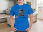 A person in a Garment Graphics blue T-shirt featuring a Scania truck graphic stands in a blurry room with a couch. Below the image, Scania and its logo are printed, ideal for truck enthusiasts.