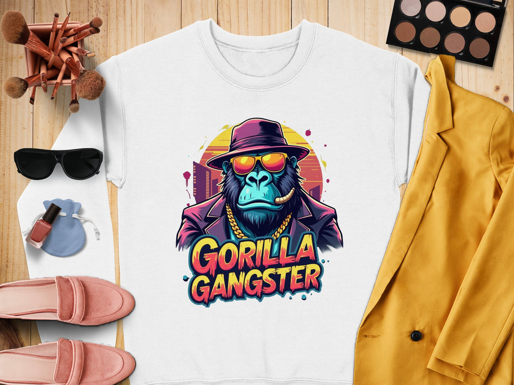 The urban white sweatshirt by Garment Graphics features a gorilla in a hat, sunglasses, and gold chain with a cigar. Gorilla Gangster is printed below. It pairs well with brushes, makeup, shoes, sunglasses, and a vibrant yellow jacket.