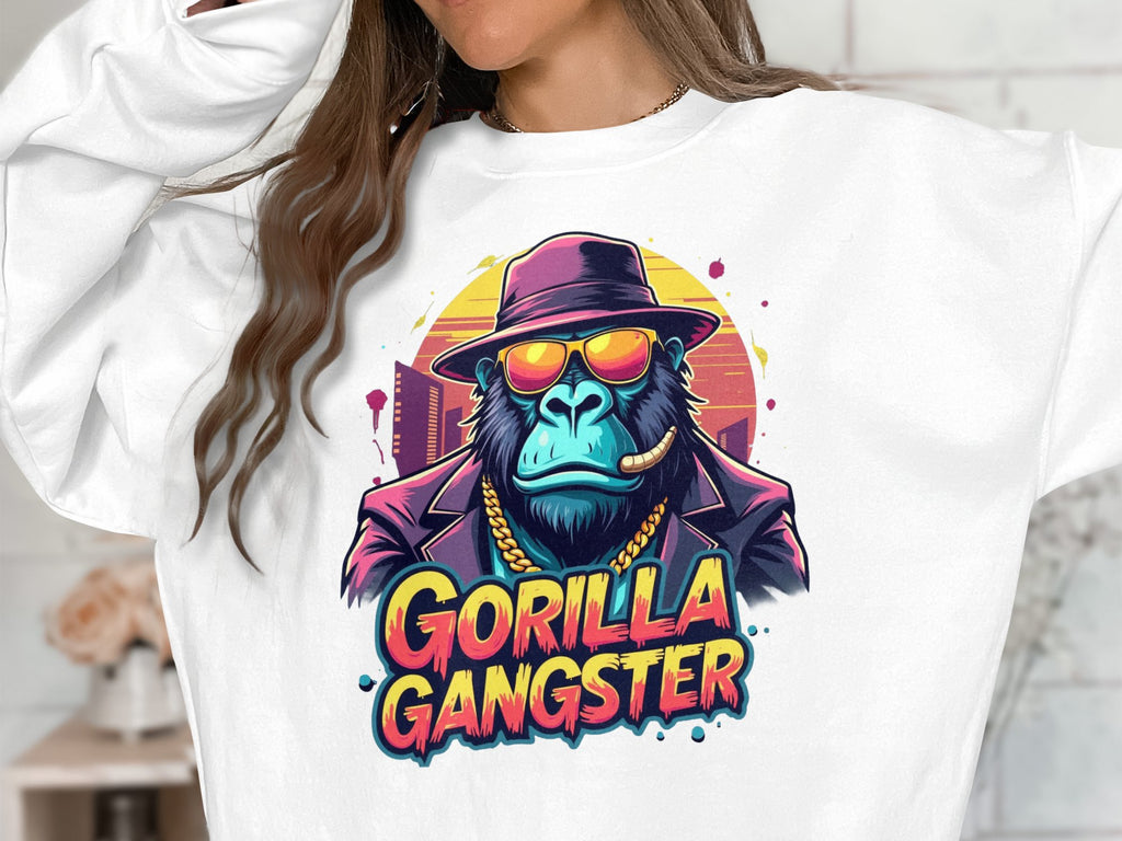 Wearing the urban-styled white sweatshirt from Garment Graphics, one showcases the Gorilla Gangster design featuring a gorilla in sunglasses, hat, gold chain, and cigar. This colorful graphic exudes edgy street flair.
