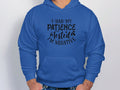 Wearing a blue hoodie by Garment Graphics, featuring I had my patience tested, Im negative in bold black text and a convenient front pocket, someone pairs it with blue jeans. The unique design stands out against a plain white background.