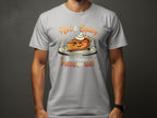 A person wears a gray Garment Graphics t-shirt featuring a cheerful pie slice with whipped cream and arms. Hot & Spicy reads above, while below it asks, You Wanna Piece of Me? Available in family sizes for those who love the spicy pie design.