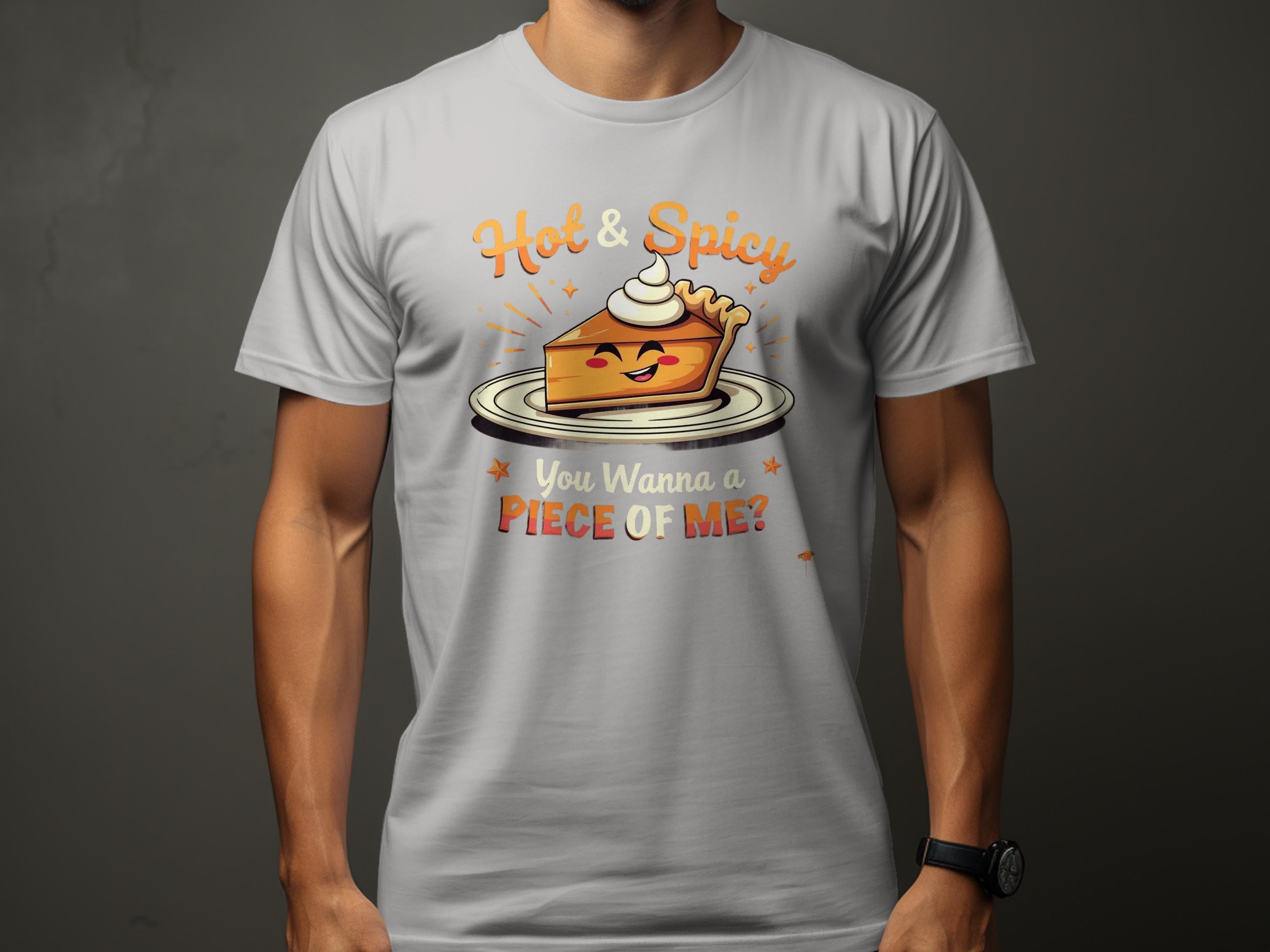 A person wears a gray Garment Graphics t-shirt featuring a cheerful pie slice with whipped cream and arms. Hot & Spicy reads above, while below it asks, You Wanna Piece of Me? Available in family sizes for those who love the spicy pie design.