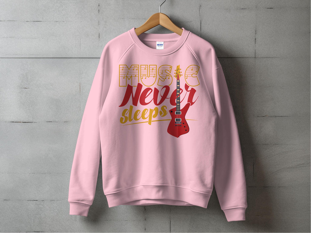 A vibrant pink Garment Graphics sweatshirt hangs on a wooden hanger against a concrete wall, ideal for music fans. It features Music Never Sleeps in bold and showcases a striking red electric guitar graphic on the right side.