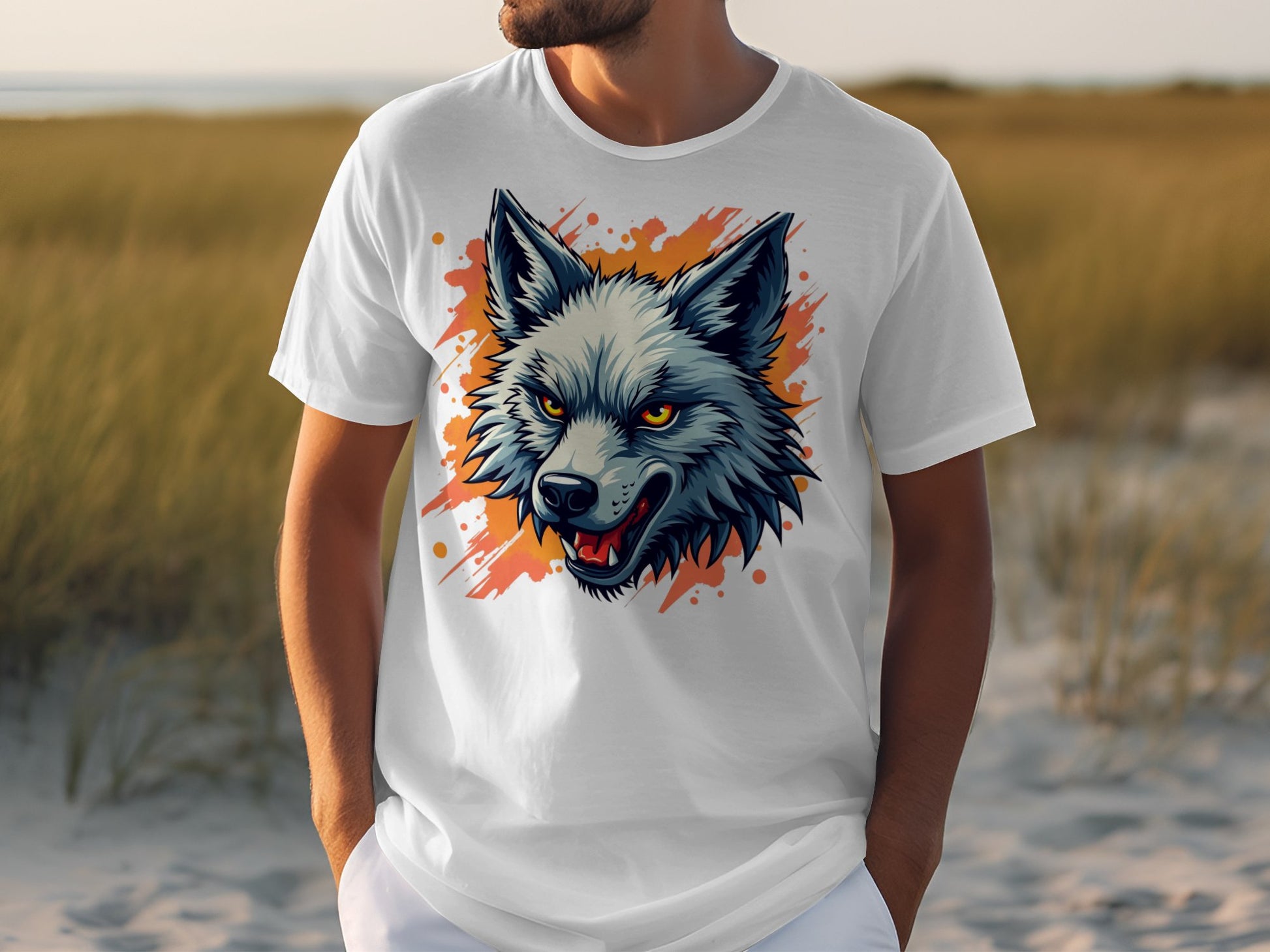 A person is wearing a stylish Garment Graphics T-shirt showcasing a colorful wolf with sharp details and an orange splash background, embodying fearlessness. They stand outdoors on sand, with grass in the background.