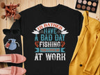 A flat lay features a Garment Graphics black unisex fishing sweatshirt with the quote, Id rather have a bad day fishing than a good day at work. Accompanied by a yellow jacket, blush pink shoes, sunglasses, makeup brushes and palette, plus a small blue pouch. Ideal for fishing enthusiasts.