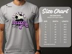 A person wears a gray Soccer Mum Garment Graphics t-shirt with a soccer ball and stars. Nearby, a classic fit Gildan 5000 heavy cotton t-shirt size chart displays small to 5XL sizes, detailing width and length in inches.