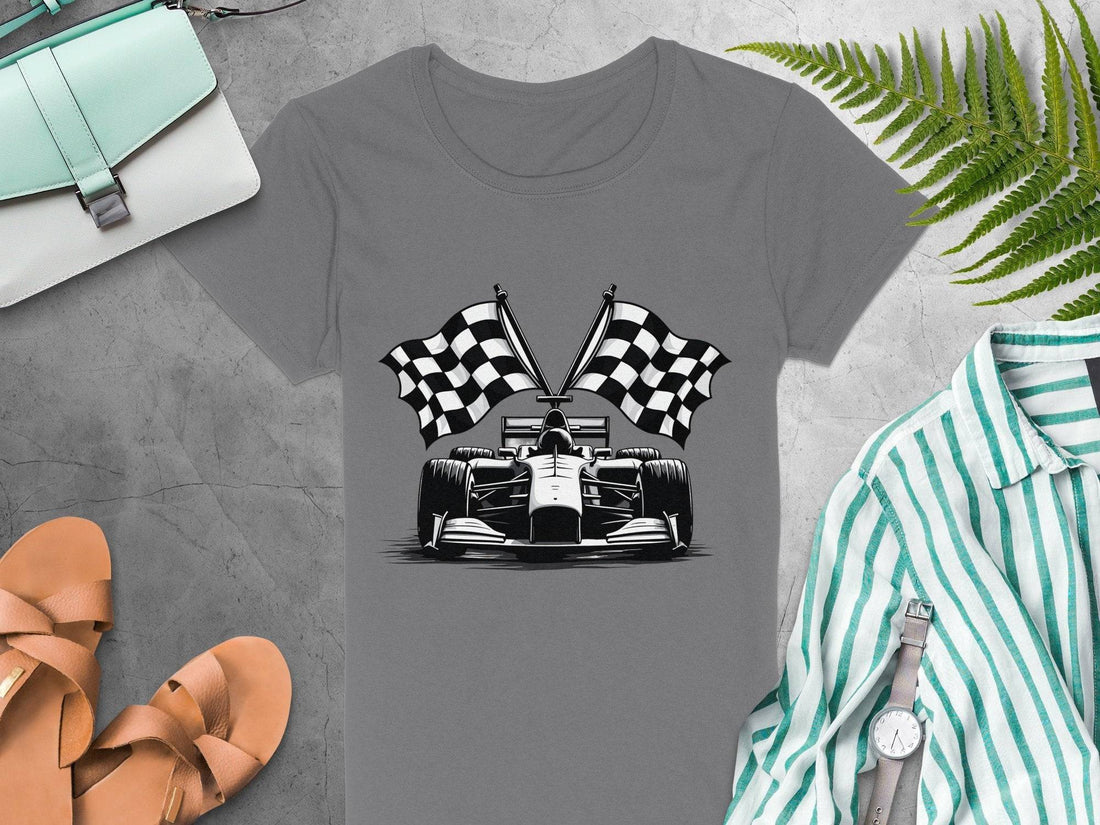 A white t-shirt with a black race car illustration and checkered flags, ideal for motorsport fans. Next is a size chart for Garment Graphics 5000L heavy cotton womens t-shirts, showing S to 3XL measurements in inches, all set against a wooden backdrop.
