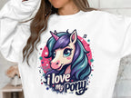 Sporting a lively graphic sweatshirt, someone displays a cartoon unicorn with purple and teal hair, encircled by colorful stars and musical notes. The Garment Graphics sweatshirt reads I love my ponyunicorn.