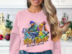 A person in a Garment Graphics pink sweatshirt, featuring a vibrant street dance graphic and Risk Taker Street Dance 10th Final text, stands by a decorated kitchen counter with long hair cascading down, perfectly capturing the street dance finals vibe.