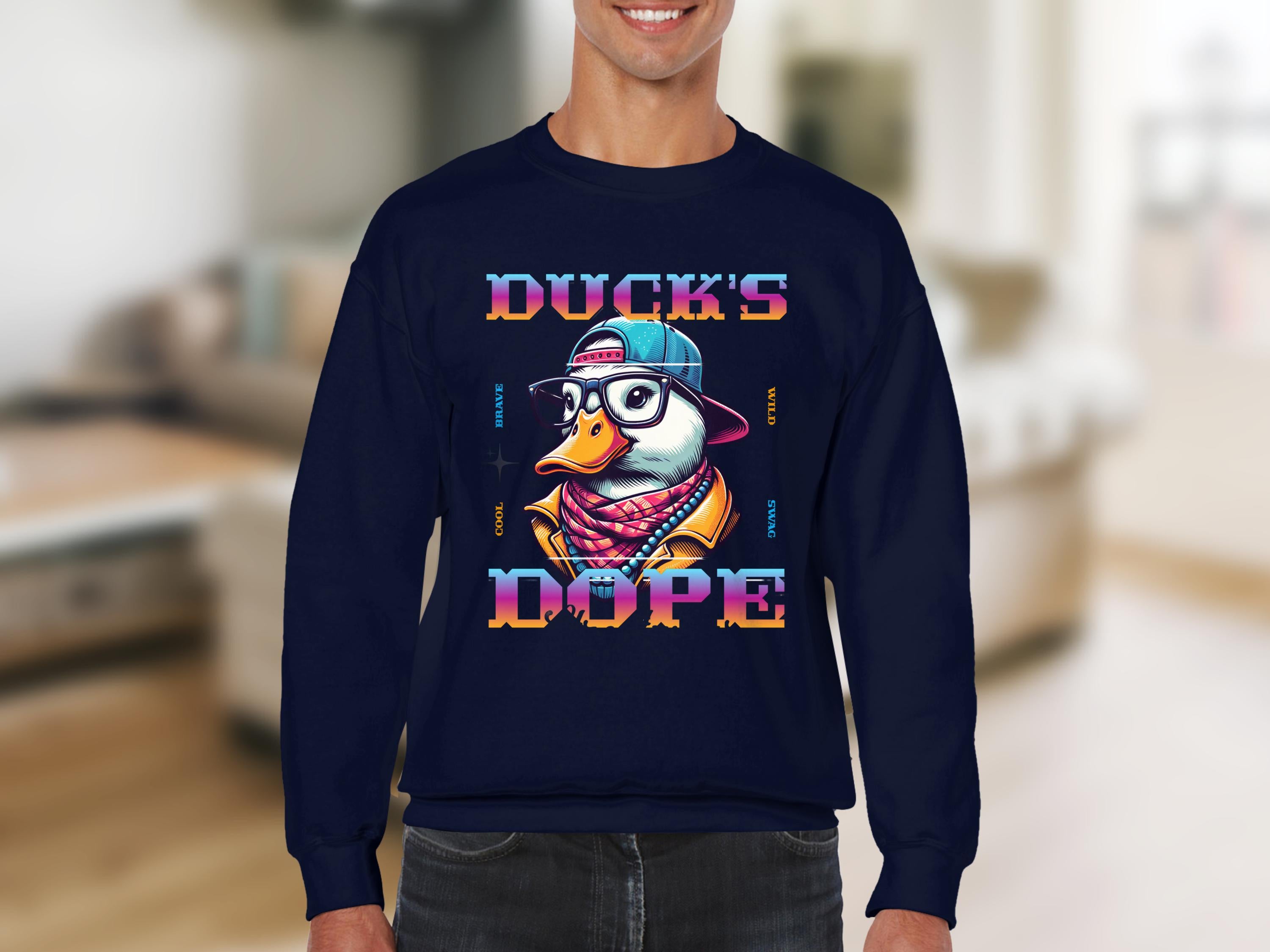 A smiling person sports a navy blue Garment Graphics sweatshirt with a trendy cartoon duck in cap and glasses. The bold Ducks Dope text enhances the design, displayed against a blurred interior backdrop.
