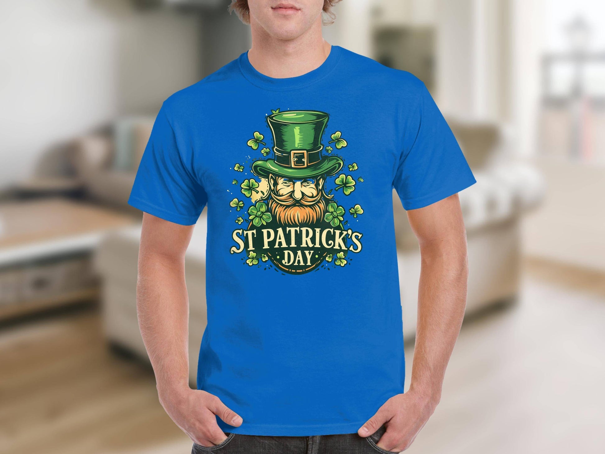 A person celebrates St. Patricks Day indoors, proudly wearing Garment Graphics Irish pride T-shirt. The shirt features a shamrock design with a green top hat, an orange-bearded face, and the text St. Patricks Day, set against a blurred background.