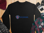 The Garment Graphics black sweatshirt with a griffin design and blue Scania logo is perfect for casual outings. It’s displayed on a wooden surface with a red knit cap, black and white gloves, plaid shirt, and scarf, offering unisex sizing for comfort.