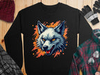 A bold Garment Graphics sweatshirt featuring a fierce illustrated wolf head with bright yellow eyes and bared teeth against an orange splash background, laid on wood and surrounded by winter wear, perfect for revealing your wild side.
