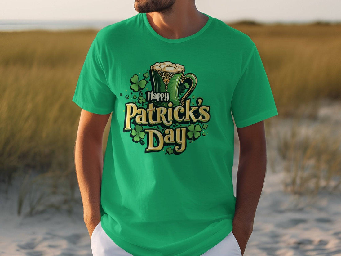 Wearing a colorful Happy Patricks Day T-shirt from Garment Graphics, adorned with shamrocks and a frothy beer mug, a person enjoys the outdoor festivities on lush grass with sandy terrain in the background, making a bold statement.