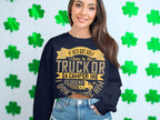 Wearing Garment Graphics humorous navy blue sweatshirt featuring the phrase, If hes got golf clubs in his truck or a camper in his driveway, I dont trust him, a person stands against a wall of green shamrocks, smiling broadly and enhancing the casual wear vibe.