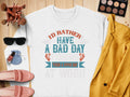 The Garment Graphics Bad Day Fishing Sweatshirt boasts the slogan Id rather have a bad day fishing than a good day at work in blue, red, and gray. Pair it with a yellow jacket, makeup brushes, sunglasses, pink shoes, nail polish, and a blue pouch for those with true fishing passion.